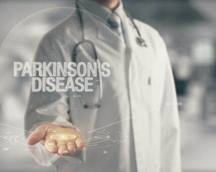 Doctor holding in hand Parkinson's Disease Concept of application new technology in future medicine